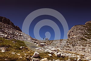 Unrecognizable trekkers seen from below at the Forcella dei Campanili in summer photo