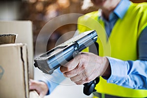 Warehouse woman worker with barcode scanner. photo