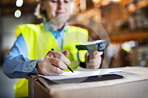 Warehouse woman worker with barcode scanner.