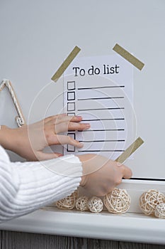 Unrecognizable woman creating vision board with Motivational paper note TO DO LIST. Goals setting concept. Strategy for