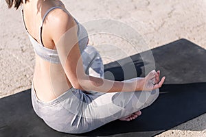 unrecognizable woman doing yoga meditation