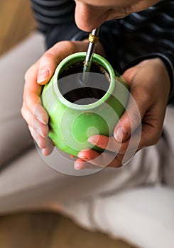 Unrecognizable woman drinking yerba mate