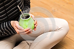 Unrecognizable woman drinking yerba mate
