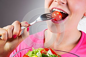 Unrecognizable woman eating salad