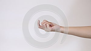 Unrecognizable woman giving beckoning finger sign. Close-up hand studio on white background. Flirt, temptation concept