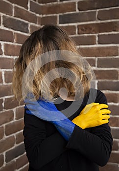 Unrecognizable woman, her face covered by hair, exhaustedly holding her hands in front of her