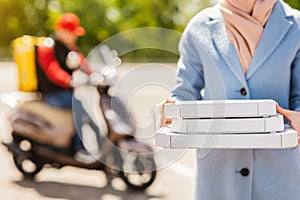 Unrecognizable Woman Holding Pizza Boxes Receiving Food From Courier Outdoor