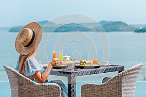 Unrecognizable woman on luxury lifestyle vacation holiday travel eats breakfast