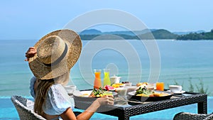 Unrecognizable woman on luxury lifestyle vacation holiday travel eats breakfast