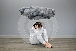Unrecognizable woman with mental disorder and suicidal thoughts under a dark storm cloud