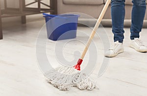 Unrecognizable woman with mop ready to clean floor