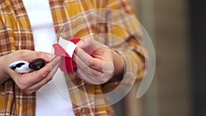 unrecognizable woman prepares kinesio tape cuts with scissors