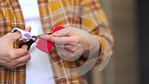 unrecognizable woman prepares kinesio tape cuts with scissors