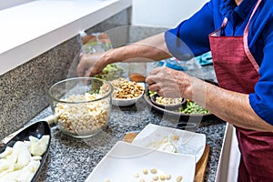 Unrecognizable woman preparing legumes to cook fanesca