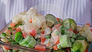 Unrecognizable woman showing into camera Frozen mixed vegetables homemade. Harvesting concept. Stocking up vegetables