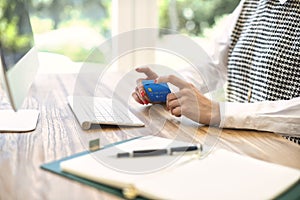 Unrecognizable woman sitting at desk and banking online