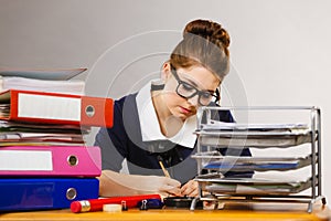 Business woman in office writing something down