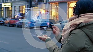 Unrecognizable woman standing on the street interacts HUD hologram with quad bike