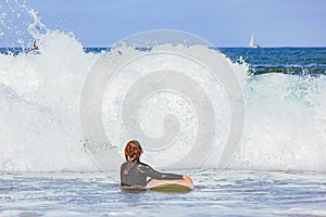 Unrecognizable woman with surfboard