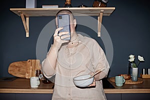 Unrecognizable Woman Taking Selfie In Kitchen