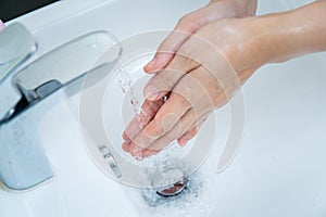 Unrecognizable woman washing a hands.