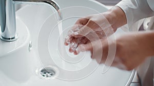 Unrecognizable Woman Washing Hands With Soap While Standing Near Sink In Bathroom