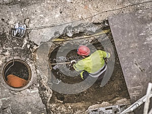 Unrecognizable workers repairing the sewage system