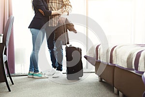 Unrecognizable young couple arrived to hotel room on honeymoon