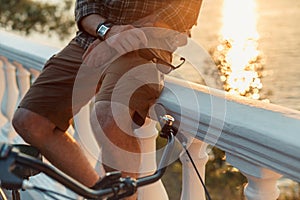 Unrecognizable Young Man With Bicycles Rests On Stone Fence Summer Vacation Travel Concept