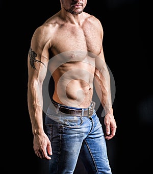 Unrecognizable young man with naked muscular torso