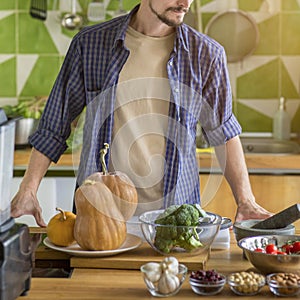 Unrecognizable young man preparing vegetables for cooking