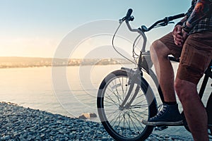 Unrecognizable Young Man Sitting On Bicycle On Coast And Enjoying View Of Sea Sunrise Resting Travel Wanderlust Concept