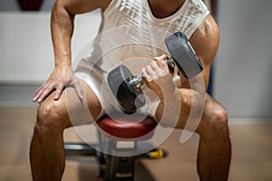 unrecognizable young man training at gym, confident bodybuilder working out with weights in sport club, bodybuilding