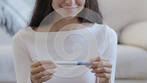 Unrecognizable young pregnant girl happy mom fertility woman expecting newborn child hold positive pregnancy test with