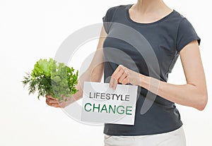 Unrecognizable young woman holding fresh greens