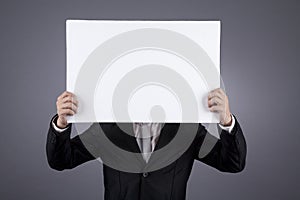 Unrecognized businessman holding a blank sign