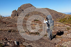 Unrecognized people using a celular smartphone in a mountain landscape photo
