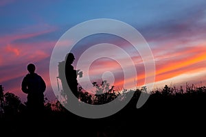 Unrecognized people using a celular smartphone in a mountain landscape