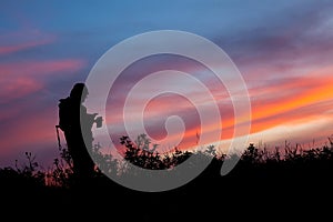 Unrecognized people using a celular smartphone in a mountain landscape