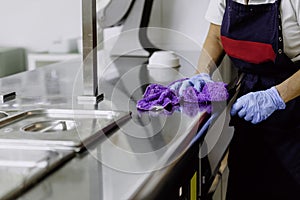 Unrecognized woman cleaning kitchen photo