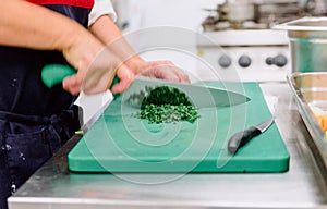 Unrecognized woman cutting parsley photo