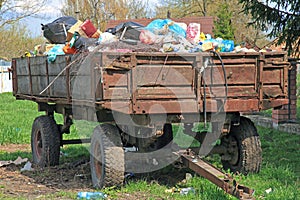 Unrecycled trash. Garbage lies in bulk on a cargo trailer from a tractor. Environmental pollution