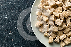 Unrefined cane sugar on plate