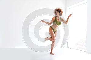 Unretouched photo of body positive gir in comfort lingerie move pointing empty space in studio interior