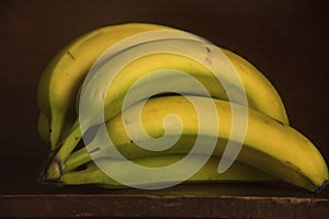 Unripe Bananas Sitting on a Shelf