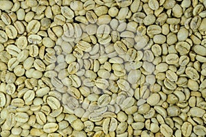 Unroasted coffee beans background, top view