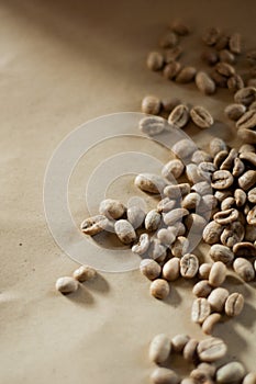 Unroasted coffee beans on brown kraft paper background