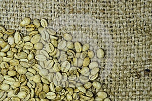 Unroasted coffee beans on hemp background