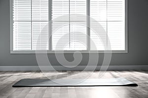 Unrolled  yoga mat on floor in room