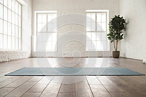 Unrolled yoga mat on wooden floor in yoga studio photo